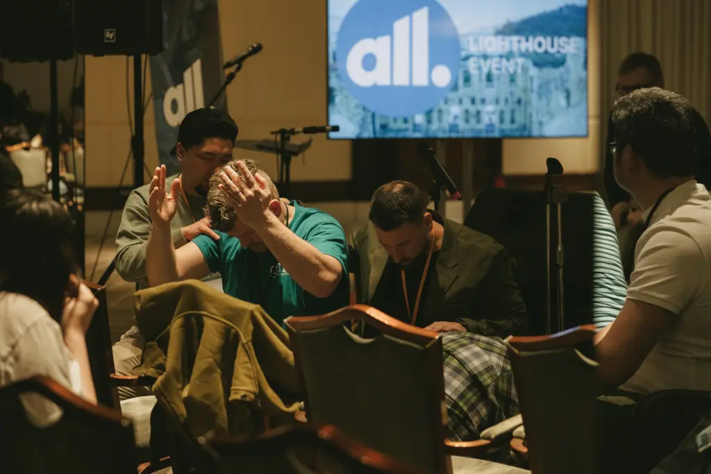 Young adults praying together as part of a growing Christian movement in Europe