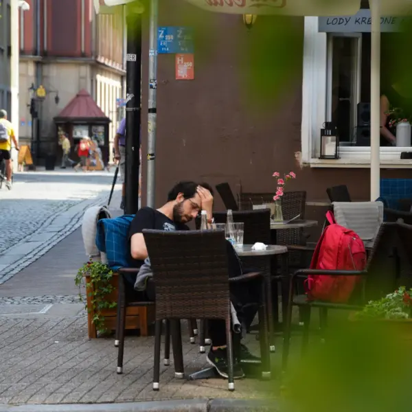 People relaxing at an outdoor café in Austria along a pedestrian street