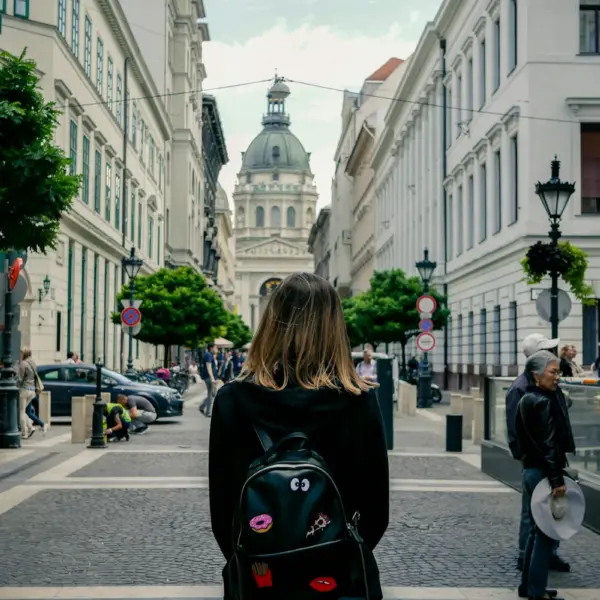 Pedestrian walking toward St. Stephen’s Basilica on a city street in Budapest, Hungary
