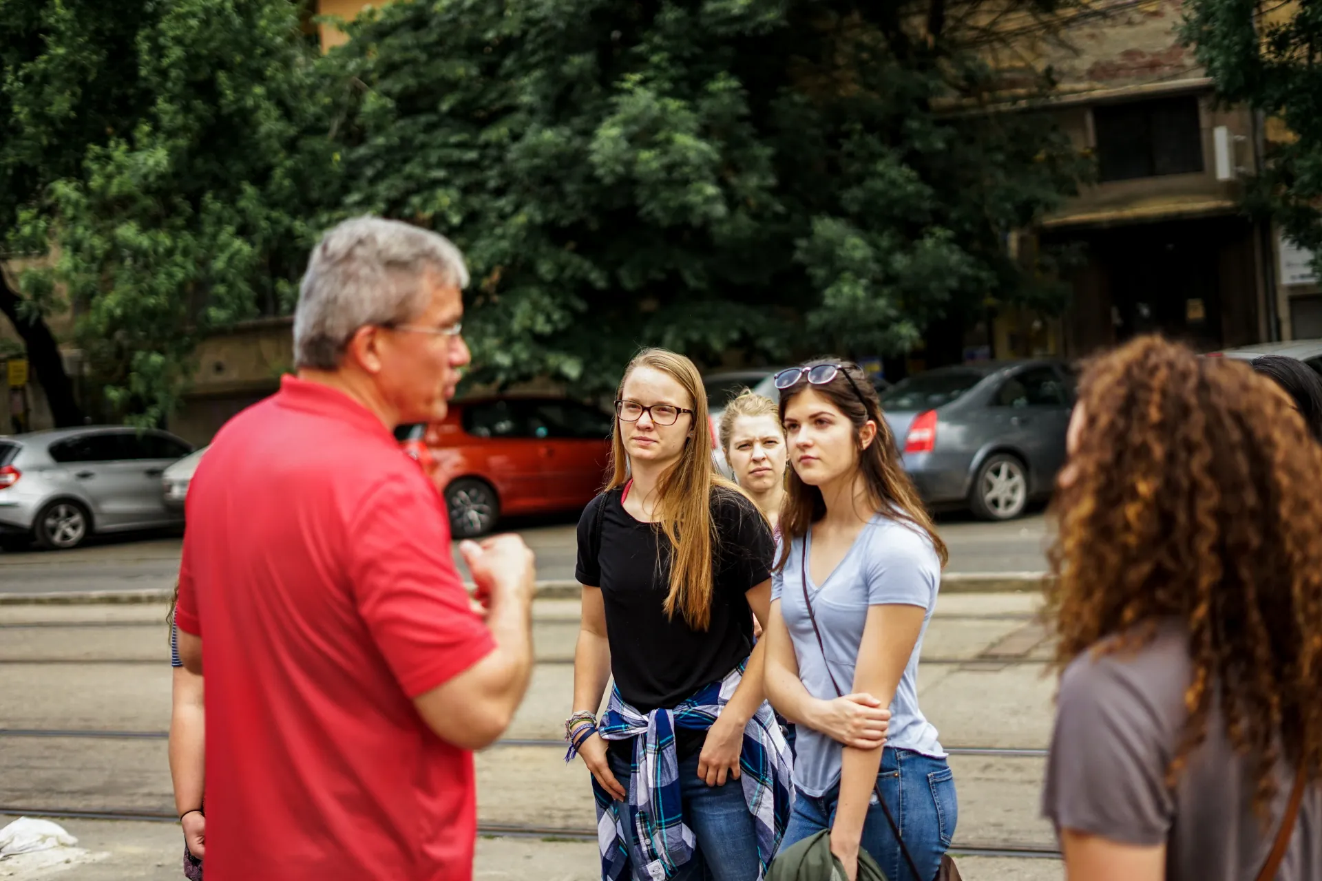 Man speaking with a small group outdoors in Romania